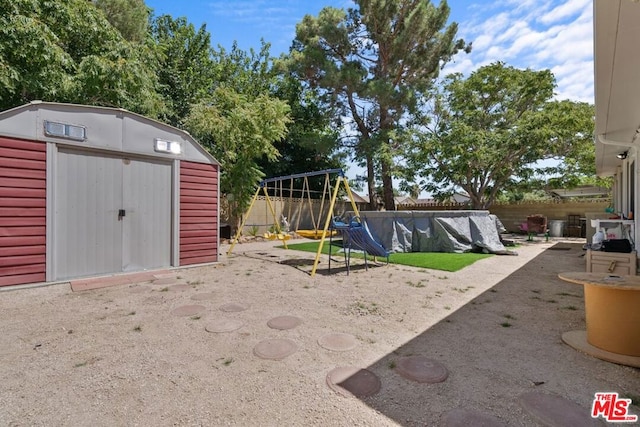 view of play area featuring a storage shed