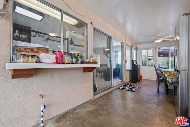 interior space with ceiling fan