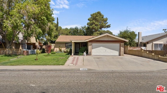 ranch-style home featuring a garage and a front lawn