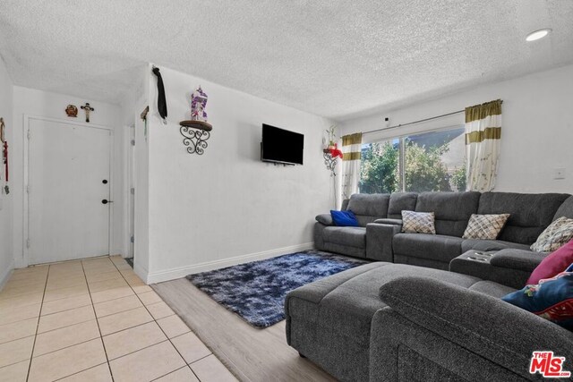 tiled living room with a textured ceiling