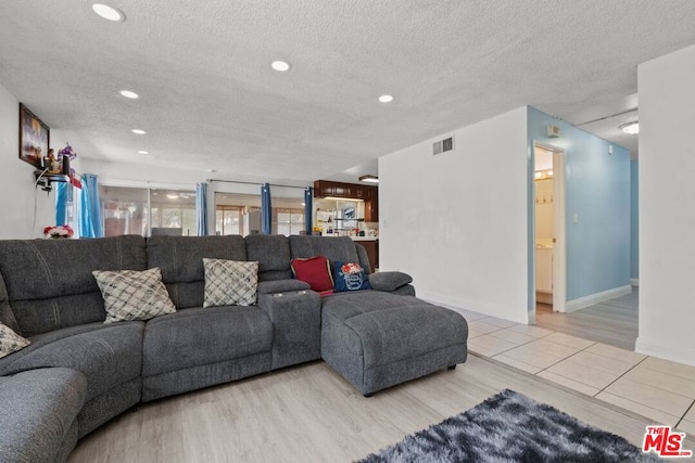 living room featuring hardwood / wood-style floors and a textured ceiling