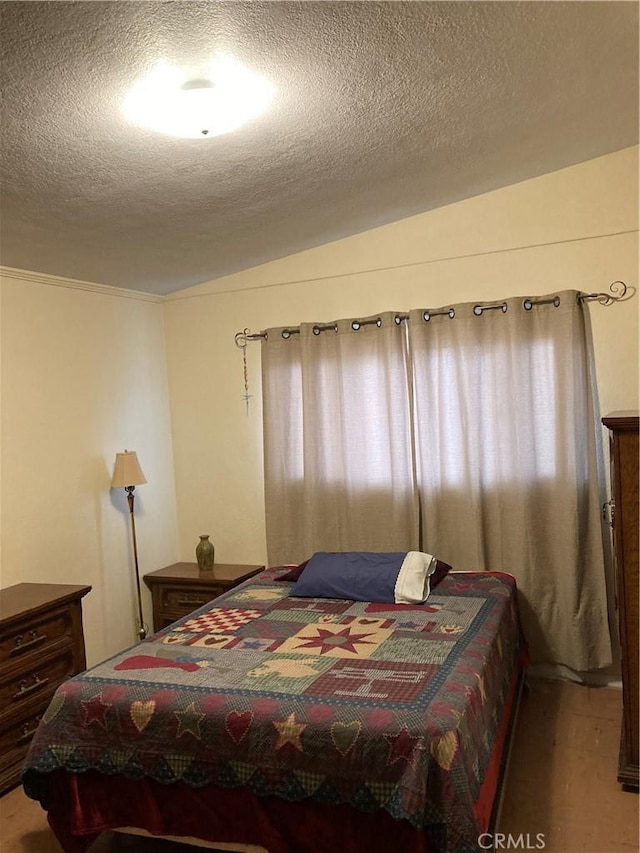 bedroom featuring carpet flooring and a textured ceiling