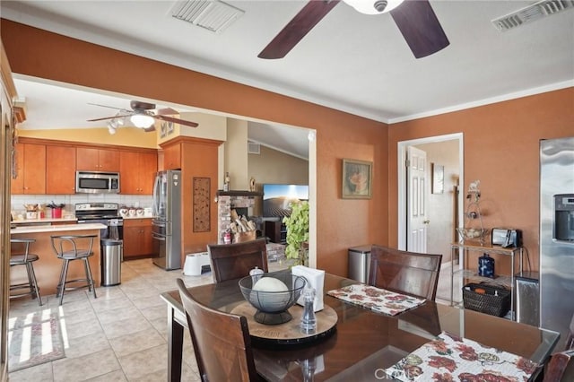 dining room with light tile patterned flooring and lofted ceiling