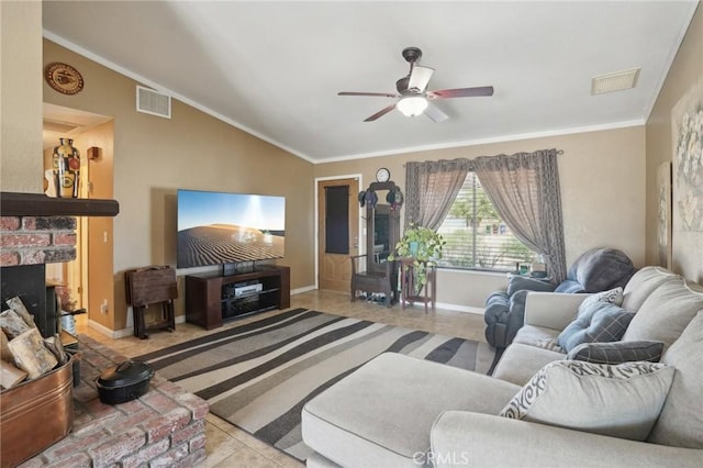 living room featuring ceiling fan, a brick fireplace, crown molding, vaulted ceiling, and light tile patterned flooring