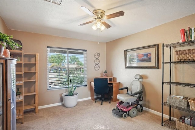 home office with ceiling fan and carpet floors