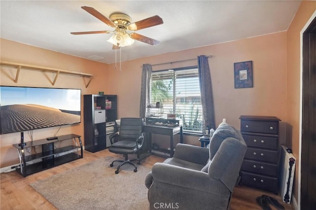 home office with hardwood / wood-style floors and ceiling fan