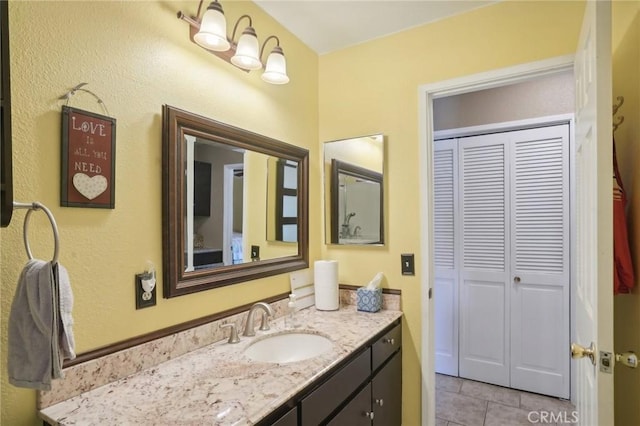 bathroom with tile patterned flooring and vanity