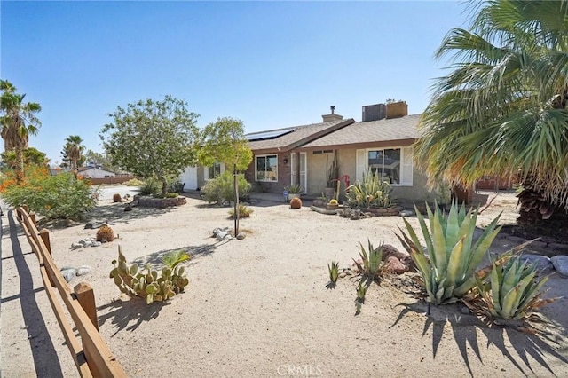 ranch-style house with solar panels