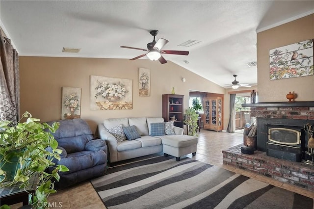 tiled living room featuring vaulted ceiling, a wood stove, ceiling fan, and crown molding