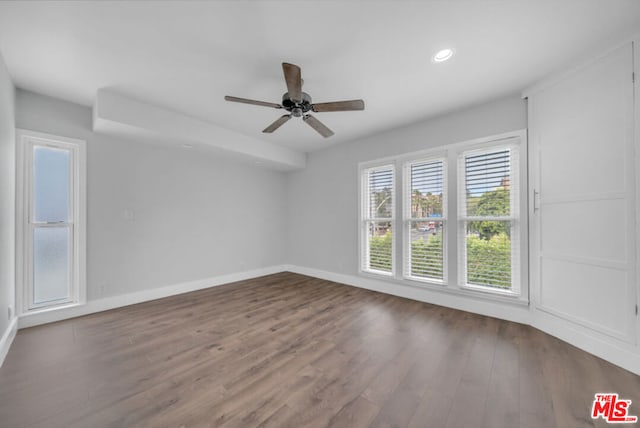 empty room featuring ceiling fan and dark wood-type flooring