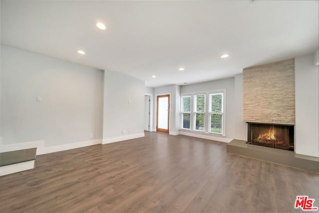 unfurnished living room featuring a fireplace and hardwood / wood-style floors