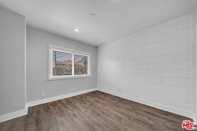 spare room with dark hardwood / wood-style flooring