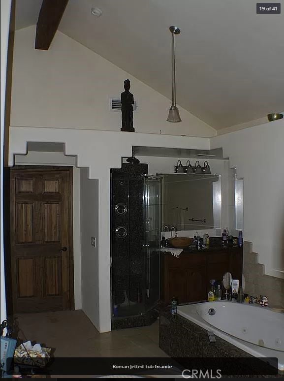 7003 Pioneer Dr, Grizzly Flats, CA 95636 - bathroom featuring lofted ceiling with beams, vanity, and independent shower and bath
