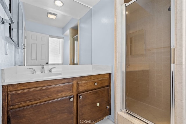 bathroom featuring walk in shower and vanity