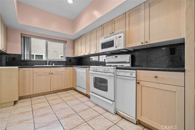 kitchen featuring backsplash, white appliances, light brown cabinets, light tile patterned floors, and sink