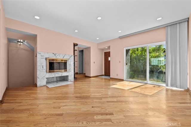 unfurnished living room featuring light hardwood / wood-style floors and a fireplace