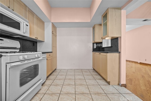 kitchen with decorative backsplash, white appliances, light brown cabinetry, and light tile patterned floors