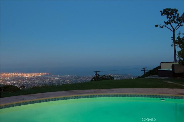 view of pool at dusk