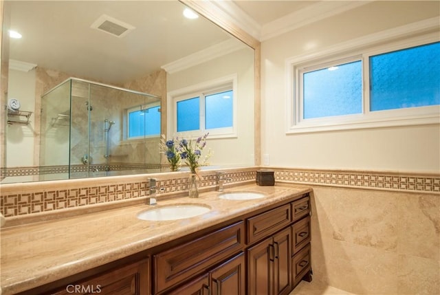 bathroom featuring walk in shower, ornamental molding, vanity, and tile walls