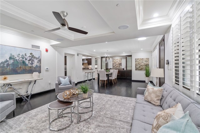 living room with ceiling fan, a raised ceiling, crown molding, and dark hardwood / wood-style flooring