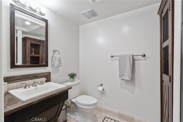 bathroom with vanity, toilet, and tile patterned floors