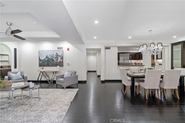 dining area featuring ceiling fan with notable chandelier, crown molding, and dark hardwood / wood-style flooring