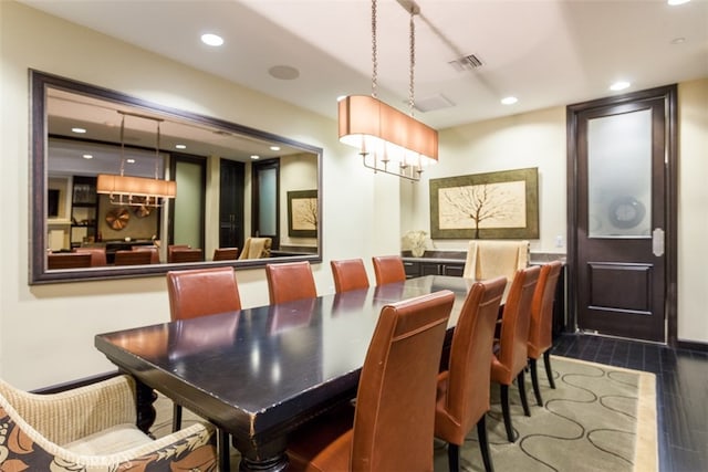 dining room with dark wood-type flooring and a chandelier