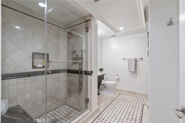 bathroom with vanity, toilet, a shower with door, and tile patterned floors