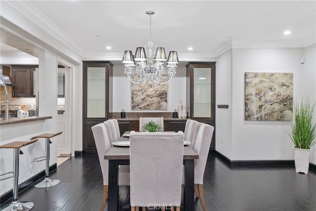 dining area with a chandelier, crown molding, and dark hardwood / wood-style flooring