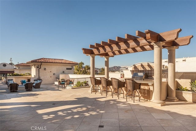 view of patio / terrace with a pergola and exterior bar