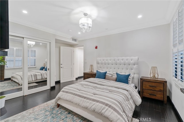 bedroom with ornamental molding, an inviting chandelier, and dark wood-type flooring