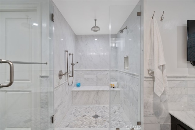 bathroom with vanity and a shower with door