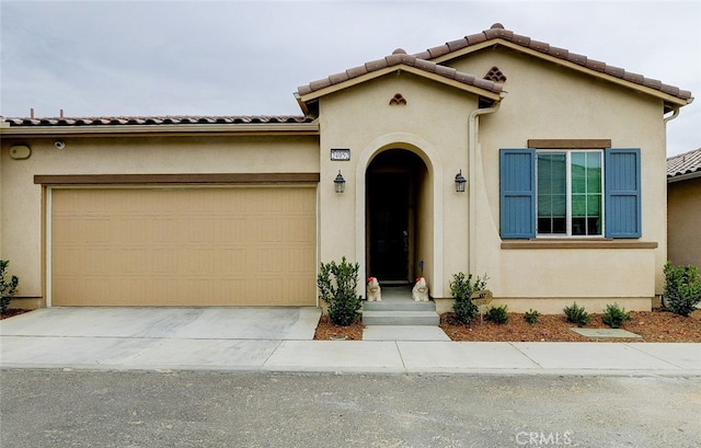 mediterranean / spanish-style house featuring a garage