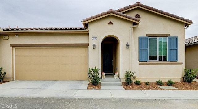 mediterranean / spanish-style house with a garage