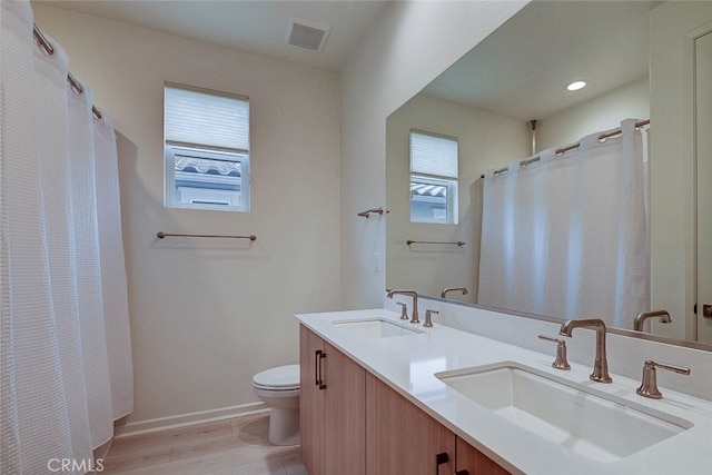 bathroom featuring vanity, a shower with curtain, wood-type flooring, and toilet