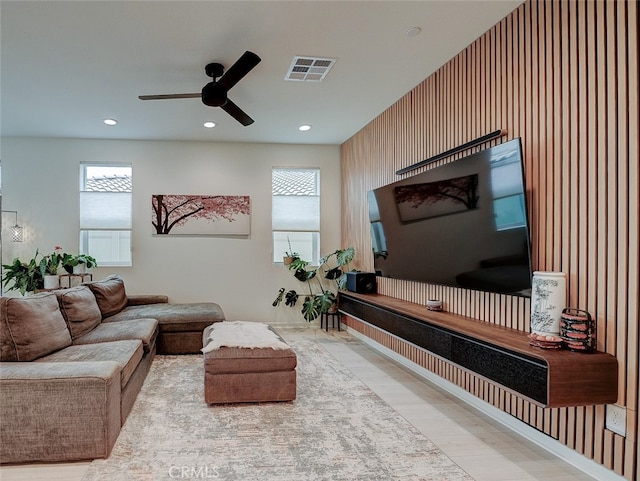 living room featuring ceiling fan and a healthy amount of sunlight