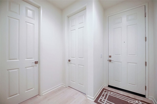 doorway to outside with light wood-type flooring