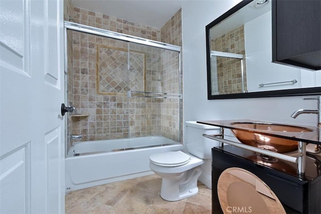 full bathroom with shower / bath combination with glass door, vanity, and toilet