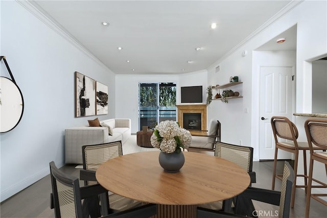 dining area with dark hardwood / wood-style floors and ornamental molding