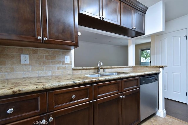 kitchen with dishwasher, backsplash, sink, dark brown cabinets, and light stone counters