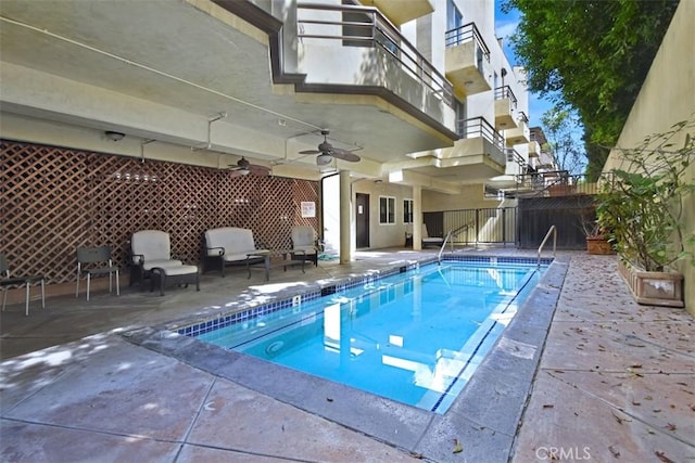 view of pool with ceiling fan and a patio area