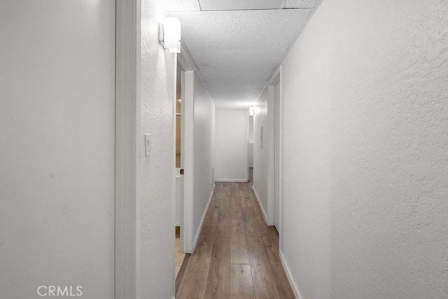 corridor with light hardwood / wood-style floors