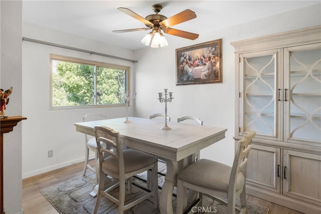 dining area featuring ceiling fan and light wood-type flooring