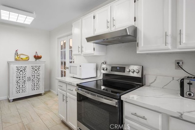 kitchen featuring light stone counters, white cabinetry, and electric stove