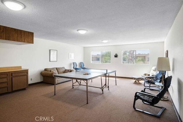 rec room featuring a textured ceiling and carpet floors