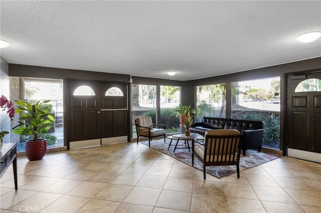 entryway featuring light tile patterned floors and a textured ceiling