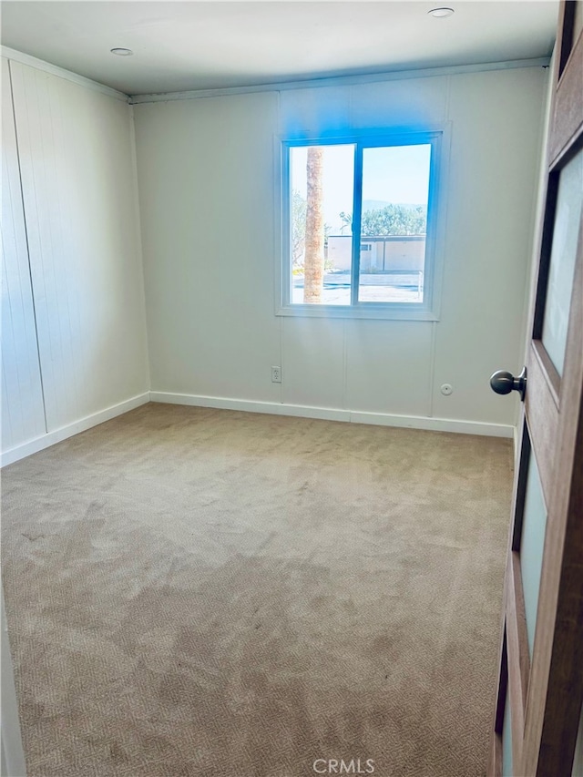 unfurnished room with light carpet