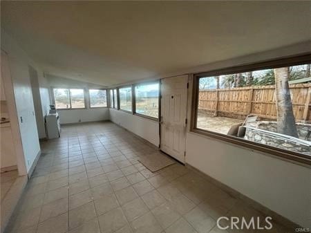 unfurnished sunroom featuring lofted ceiling