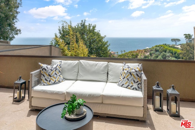 balcony featuring a water view and a patio