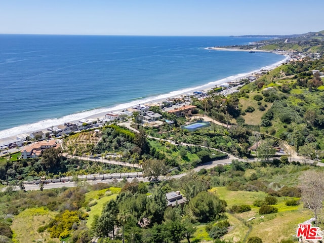 aerial view with a water view and a beach view